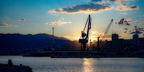 Obraz premium industrial port on the Adriatic coast at dusk, early summer