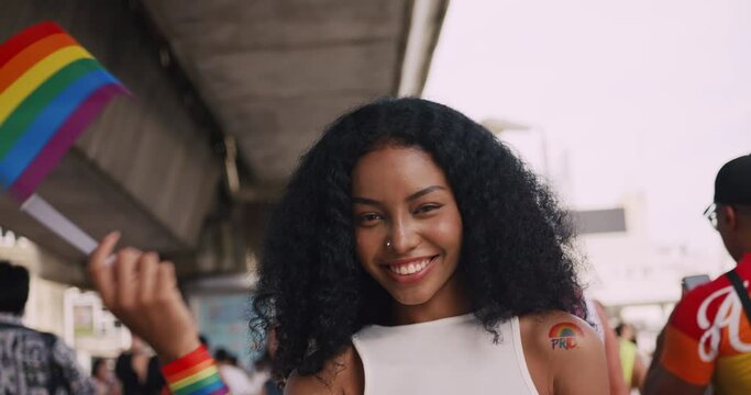 A young black woman shows off her homosexual identity in a pride parade.