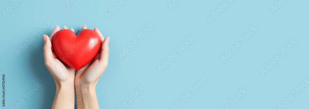 Wall mural Red heart in man's hands isolated on blue background. Healthcare and hospital medical concept. Symbolic of Valentine day.Top view with space for text. Banner.Generative AI - Wall murals