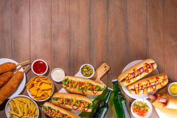 National Hot Dogs day background, hotdog summer party festival foods, Various type of traditional hot dogs - french, corn dog, classic. mexican loaded hotdog, with snack, beer bottles and sauces