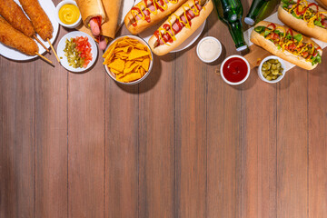 National Hot Dogs day background, hotdog summer party festival foods, Various type of traditional hot dogs - french, corn dog, classic. mexican loaded hotdog, with snack, beer bottles and sauces