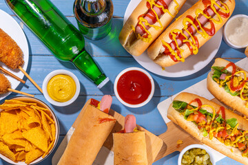 National Hot Dogs day background, hotdog summer party festival foods, Various type of traditional hot dogs - french, corn dog, classic. mexican loaded hotdog, with snack, beer bottles and sauces