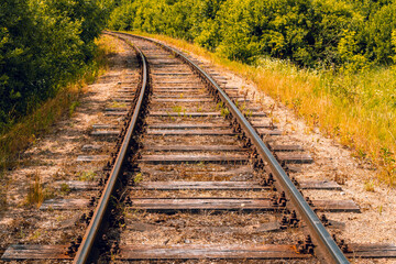 Fototapeta premium Old railway curves through the forest