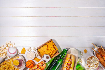 Traditional sport stadium foods and beer background, Set of various baseball, basketball, football fans and stadium snacks, chips, sauces, hot dogs with beer bottles and fan accessories 