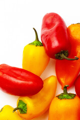 Fresh raw vegetables. Organic produce. Red and yellow peppers. Sweet pepper. White background. Above. Top view. Close up. Macro. Healthy eating. Vegetarian.