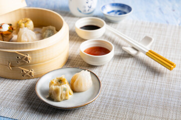 Dim sum steamed in a bamboo basket.