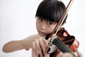 Little asian boy playing violin isolated on white background