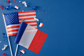 The concept of friendship between France and the USA. Top view composition of french flag, american flagб stars, hearts, confetti on blue background with empty space for advert or text