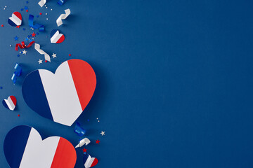Idea for patriotic celebrations on Bastille Day. Top view composition of paper hearts, stars, glittering on blue background with empty space for advert or message - Powered by Adobe