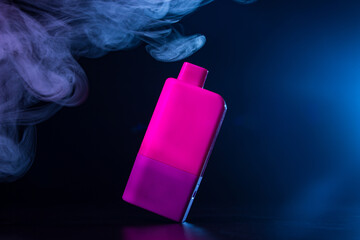 Vape in smoke with colored lighting on black background