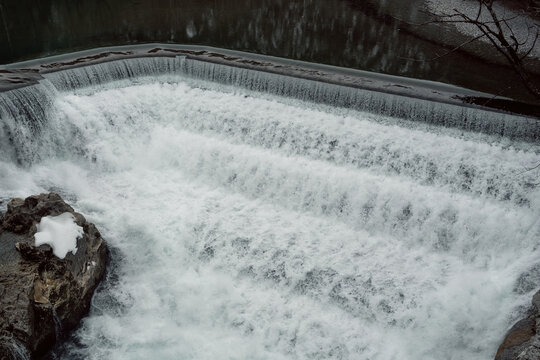 water that flows through the lech fall and is on its way towards the valley. Photographed from a bridge that leads over the Lech. Recorded in winter.