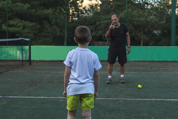 strict coach scolding his student during tennis practice