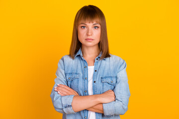 Isolated portrait of confident business woman with crossed arms over bright color background