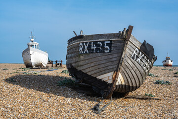 Old boats on a shinlge beach