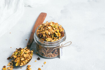 Granola with raisins and pumpkin seeds in a jar