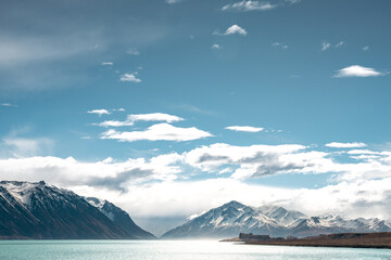 Scenic view of Lake Tekapo east bank. Beautiful view driving along the Lilybank Road from Lake Tekapo Park towards Motuariki View Point. Motuariki island can be seen from the view point.
