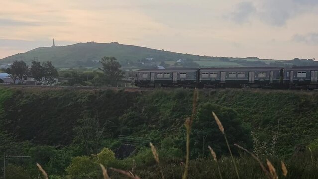 an early train passing through dolcoath mine on the way to redruth from camborne cornwall uk