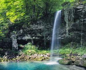Fototapeta premium Beautiful Italian nature. Mountain waterfall. Antique mill waterfall (cascata antico mulino), Udine province, Friuli Venezia Giulia, Italy.