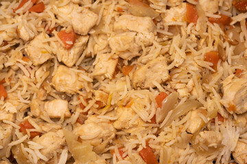 Tasty pilaf with chicken as background.