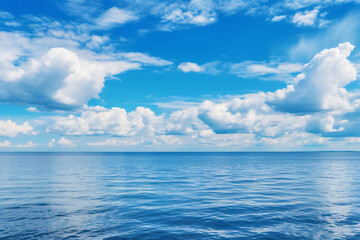Obraz premium Calming summer natural marine blue background . sea and sky with white clouds photography