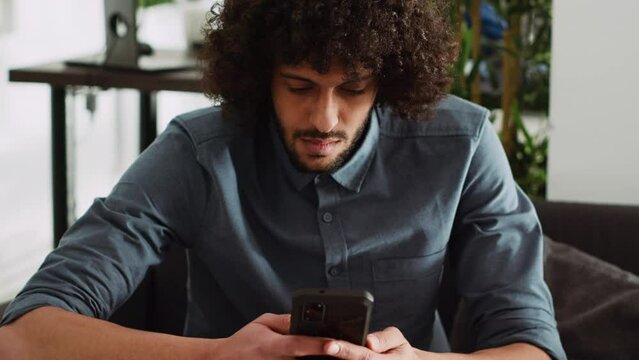 Employee analyzing statistics data on smartphone, browsing online phone app in office. Marketing specialist planning project with analytics and annual information, small business. Handheld shot.