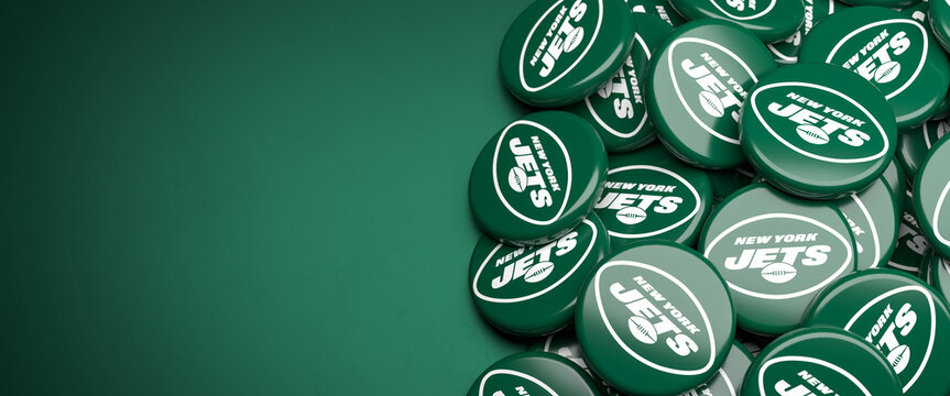 Logos of the American Football Team New York Jets on a heap on a table.