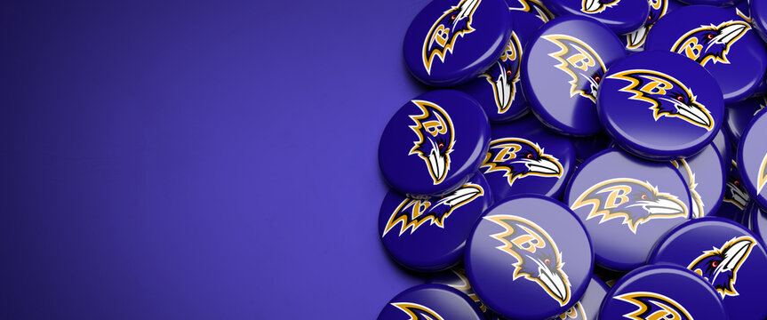Logos of the American Football Team Baltimore Ravens on a heap on a table.