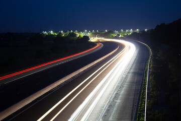Fototapeta na wymiar Highway Trails: Captivating Long Exposure Light Streaks at Junction 8/9 on the M40 Create a Spectacular Visual Display
