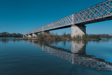 old stone and metal bridge over the river