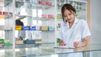 Asian woman pharmacist working at Pharmacy Drugstore . Medical healthcare concept