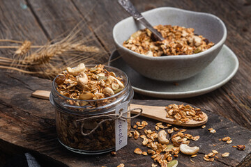 Granola with nuts, raisins and pumpkin seeds in a glass jar