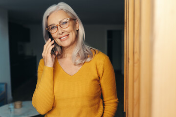 Mature woman making a phone call, staying connected with a smartphone