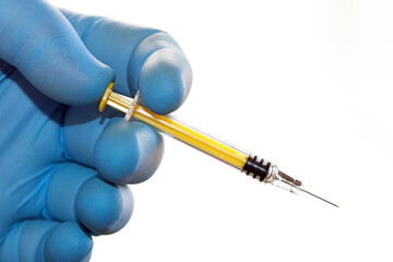 Doctor's or researcher's hand with a small, vaccine, insulin, or heparin syringe.