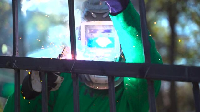 Welder Working on a Residential Fence in Slow Motion