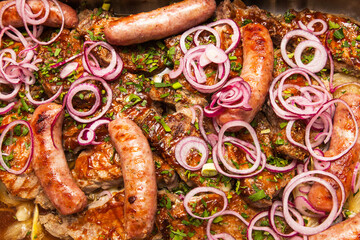 Fried sausages and meat sprinkled with fresh chopped onions and herbs.
