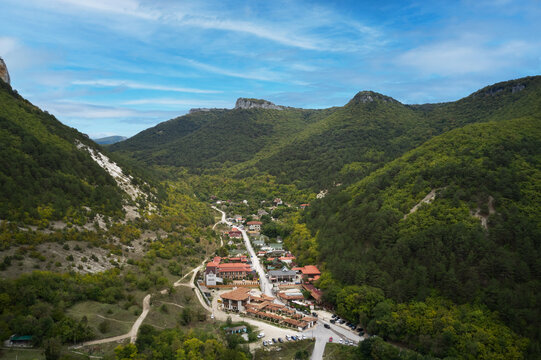 A picturesque aerial view of a mountain village near Lake Mangup in the Crimea. Shot from a drone.