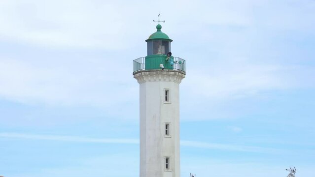 Green lighthouse of the Old Port of La Rochelle on the Quai Valin street