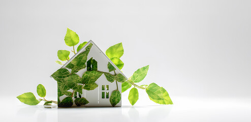 Small house figurine and green foliage on white background, free copy space, eco nature concept, AI generated