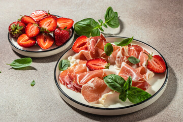 Slices of prosciutto di parma or jamon serrano iberico with strawberries, Antipasto Dinner or...