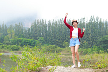 Asian female tourists enjoying the trip Standing in the wild nature. Travel concept. hiking adventure. copy space