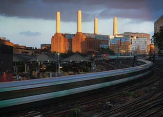 Battersea Power Station at night with train, sun setting