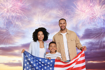 4th of July - Independence day of America. Happy family holding national flag of United States against sky with fireworks - Powered by Adobe