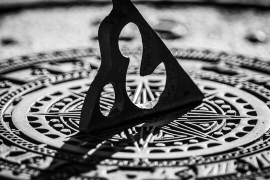 Close-up black and white shot of a sundial in summer 