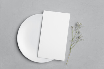 Blank paper menu card mockup with white plate and dry botanical decor, mockup with copy space