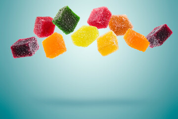 assorted jelly candies floating on blue background. - 617099318