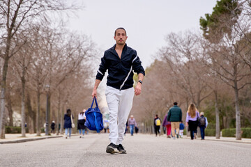 manwith sports backpack on his way to the gym