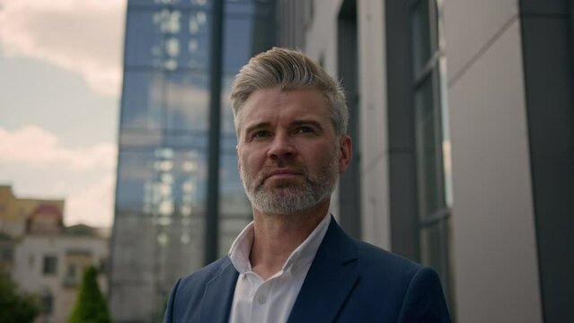 Outdoors portrait Caucasian elderly senior man mature business manager middle-aged employer old businessman serious pensive confident successful entrepreneur leader investor boss in city looking away