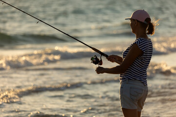 Woman fishing in the sea with a line