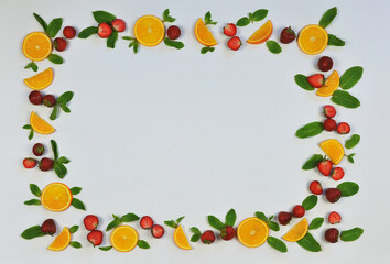 Frame of fresh strawberries , green mint leaves and sliced oranges on white background. Top view ,flat lay .Vitamin ,fresh, healthy dessert concept. Free copy space. 