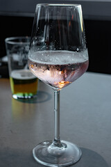 Rose wine glass standing in the evening sun on a table